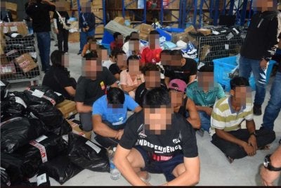 Antara warga asing yang ditahan dalam serbuan di sebuah gudang pada Rabu.
