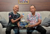 Malek Razak (kanan) menyampaikan bantuan kepada Mohd Azuan.