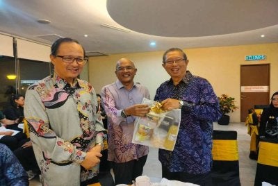 Nordin (tengah) menyampaikan cenderahati kepada Mohammad Nizar (kanan) disertai Mustaffa Kamil sempena Majlis Makan Malam Mesyuarat Strategik Rangka Kerja Kerjasama Pembangunan antara SBPAC dan Persatuan Pembangunan Komuniti Daerah Perak Tengah di Ipoh pada Selasa.