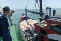 Anggota Jabatan Perikanan dan Maritim Malaysia memeriksa salah sebuah bot nelayan dalam operasi dijalankan.