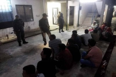 Antara warga asing yang ditahan dalam serbuan di Apartmen Seri Semarak, Bukit Beruntung pada Khamis.
