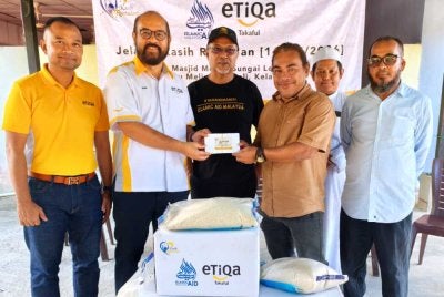 Zawahir (tiga dari kiri) dan Zafri (dua dari kiri) menyampaikan sumbangan kepada bekas pengamal media di Kelantan pada Jelajah Kasih Ramadan IAM dan Etiqa Takaful yang diadakan di Masjid Mukim Sungai Long, Batu Melintang, Jeli pada Jumaat.Foto Sinar Harian/Hazelen Liana Kamarudin