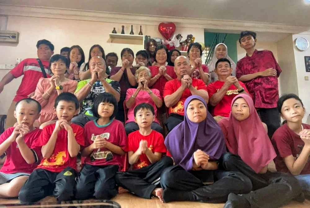 Ridhuan (duduk tengah dua dari kanan) bersama ibu (tiga dari kiri) serta ahli keluarga lain berkumpul menyambut Tahun Baharu Cina