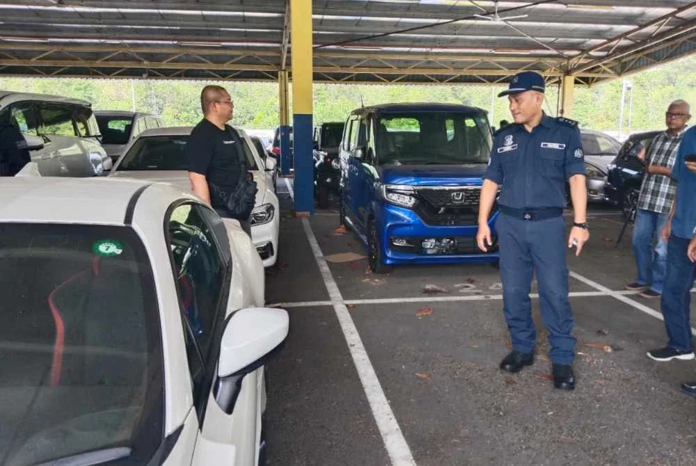 Aminul Izmeer (dua, kiri) menunjukkan beberapa kenderaan mewah yang disita melalui operai khas Ops Terma di Depo Kastam.