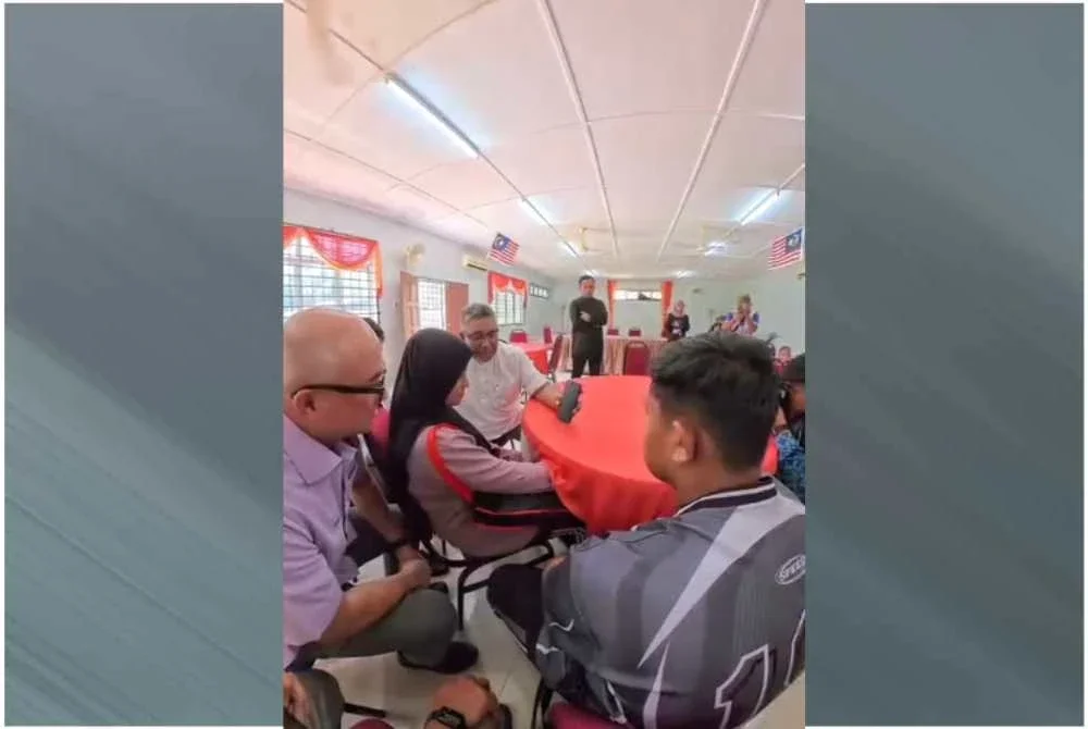 Ruby Adalia Balqis (dua dari kiri) dan Ahmad Balia Murqam (kanan) menerima panggilan video daripada Ahmad Zahid pada Jumaat.