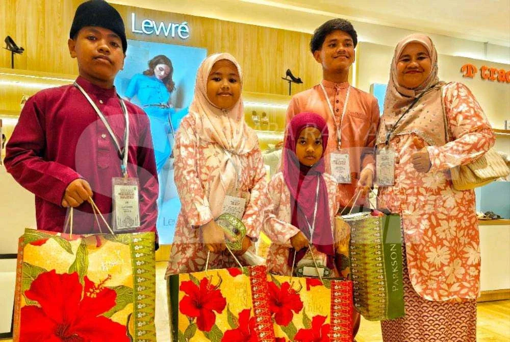Junaidah bersama empat anaknya yang menerima bantuan daripada YKM untuk membeli pakaian sempena Hari Raya.