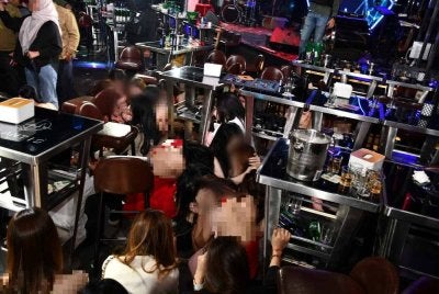 Antara wanita warga asing yang ditahan imigresen dalam serbuan Op Gegar di pusat hiburan di Kepong, Kuala Lumpur pada Jumaat. FOTO: Imigresen 