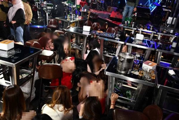 Antara wanita warga asing yang ditahan imigresen dalam serbuan Op Gegar di pusat hiburan di Kepong, Kuala Lumpur pada Jumaat. FOTO: Imigresen 