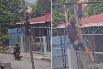Tangkap layar video tular memaparkan aksi berani dan nekad seorang lelaki memanjat tiang elektrik untuk memotong kabel.
