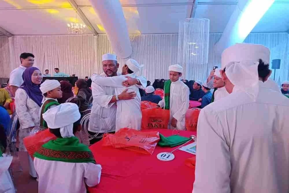Ramli menyantuni pelajar tahfiz pada Majlis Iftar bersama anak-anak yatim dan pelajar tahfiz di Petals Event Space, pada Isnin.