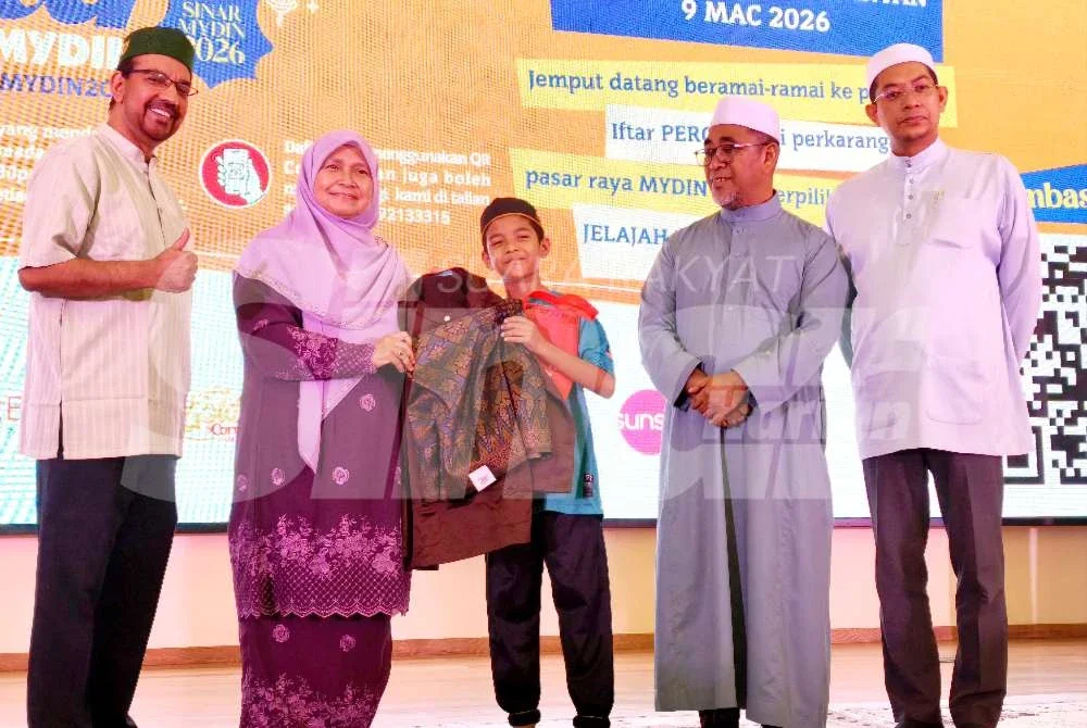 Dr Hafidzah (dua dari kiri) bersama Saizol (kanan), Abd Rahman (dua dari kanan) serta Salim (kiri) menyampaikan sumbangan baju raya kepada penerima pada Jelajah Iftar Sinar Mydin 2026 yang berlangsung di Pasar Raya Mydin Tunjong, Kota Bharu pada Isnin.