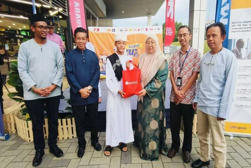 Fuziah menyampaikan sumbangan baju raya kepada pelajar Madrasah Darul Uloom Jengka 11 dari pihak penaja sempena Program Jelajah Iftar Sinar Mydin 2026 di Dataran Mydin Jengka pada Rabu.