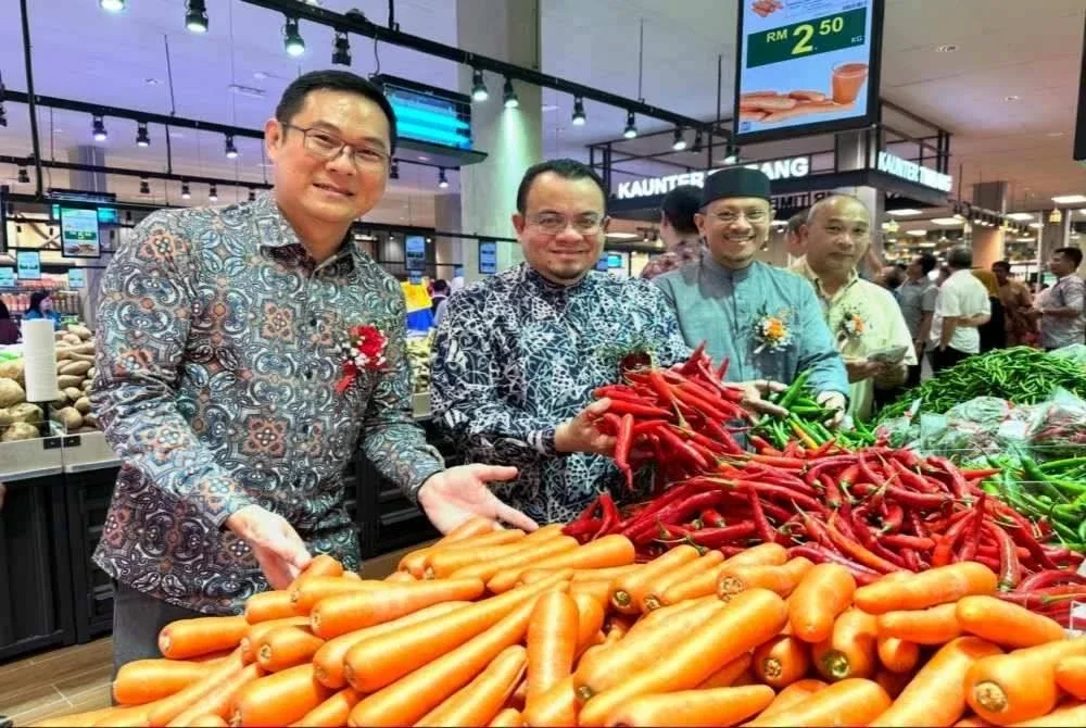 Teik Ee (kiri) mengiringi Hilmi (dua dari kiri) melihat sayur-sayuran di Pasaraya Kito.
Foto: SINAR HARIAN/ADILA SHARINNI WAHID