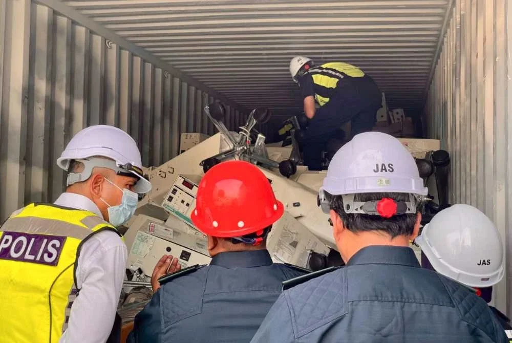 Pegawai penguat kuasa menjalankan pemeriksaan ke atas kontena disyaki mengandungi e-waste.