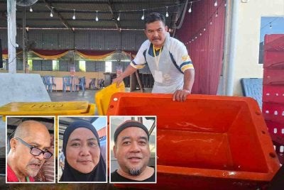 Seorang petugas menunjukkan tong berisi bekalan ayam yang telah kosong selepas 2,000 bekalan ayam habis dijual dalam tempoh kurang 40 minit di Jualan Murah Pusat Khidmat Parlimen Bukit Gantang, pada Rabu. Dari kiri: Mohd Zalie, Nor Azlina, Rosmaini