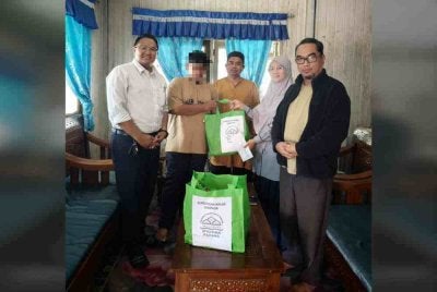 Dr Hasiah menyampaikan sumbangan PGSMP ketika menyantuni waris mangsa pada Selasa. Foto PGSMP