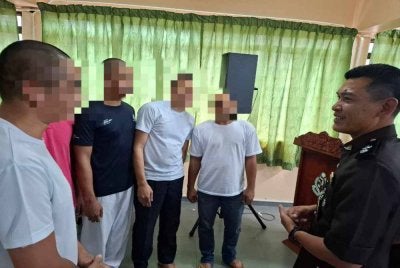 Faiz (baju biru) bersama Penguasa Penjara Taiping, Shahrul Izzat Hamid (kanan) semasa program PBSL Ihsan Madani sempena Aidilfitri, Rabu lalu.