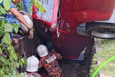 Pasukan bomba melakukan operasi mengeluarkan mangsa yang tersepit dalam pacuan empat roda di Batu 7, Sandakan.