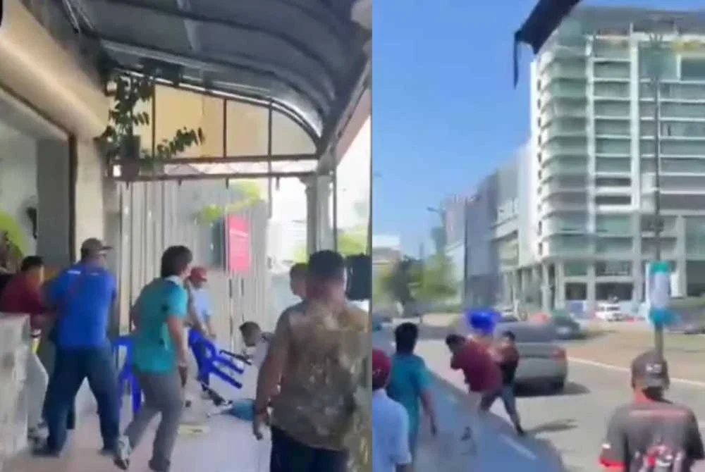 Tangkap layar video tular yang memaparkan pergaduhan dua individu di kawasan Jesselton Point, Kota Kinabalu pada Ahad.
