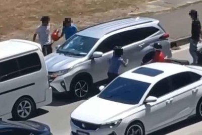 Sekumpulan lelaki bertindak agresif terhadap sebuah kenderaan di tepi jalan pusat bandar Kota Kinabalu.