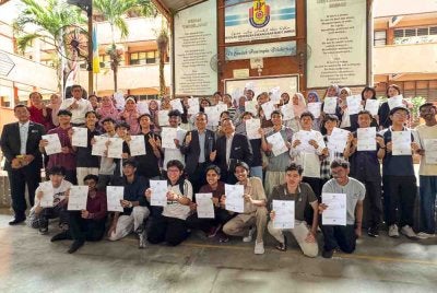 Mohammad Dziauddin (tengah) bersama pelajar SPM Sekolah Menengah Kebangsaan Bukit Jambul selepas mengumumkan keputusan SPM 2025 pada Selasa.