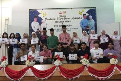Muhyiddin (tengah) bergambar dengan pelajar cemerlang SPM Parlimen Pagoh.