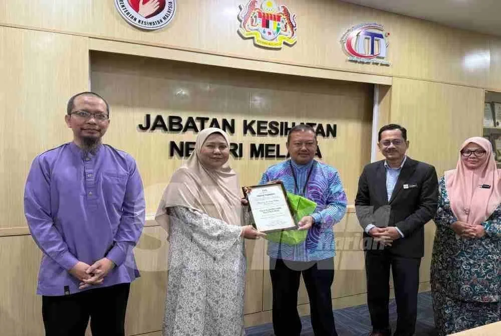 Dr Azhar menyampaikan siji penghargaan kepada Marhaini mewakili WUIF.