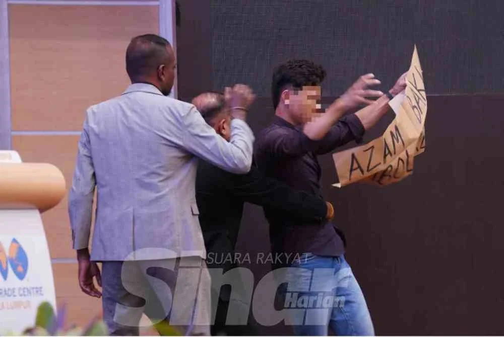 Kekecohan yang dilakukan oleh seorang lelaki sambil memegang sepanduk tercetus semasa ucapan Azam di WTC, Kuala Lumpur pada Selasa. Foto: ROSLI TALIB