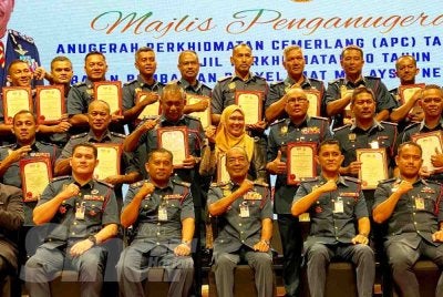 Ahmad Izram (duduk, tengah) bergambar bersama penerima APC semasa hadir merasmikan Majlis Perkhidmatan Cemerlang (APC) Tahun 2025 dan Sijil Perkhidmatan 30 Tahun JBPM Kelantan di Kota Bharu pada Selasa. 