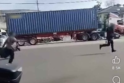 Tangkap layar video tular memaparkan seorang lelaki ketika mengejar anggota polis dalam satu kejadian di Kuala Langat pada Selasa.
