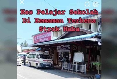 Tangkap layar video tular memaparkan ambulans membawa pelajar yang didakwa mengalami strok haba.