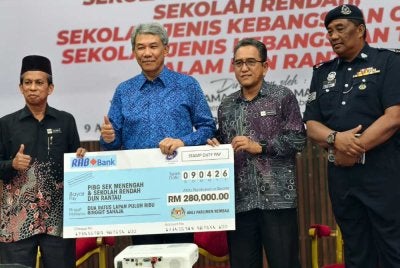 Mohamad (dua dari kiri) menyampaikan replika cek sumbangan kepada PIBG Sekolah DUN Rantau.