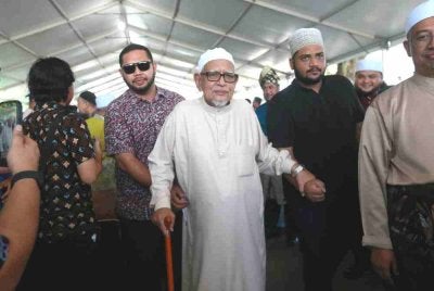 Abdul Hadi (tengah) ketika hadir di Jamuan Hari Raya Pas Terengganu di Dataran Shahbandar di Kuala Terengganu pada Khamis.