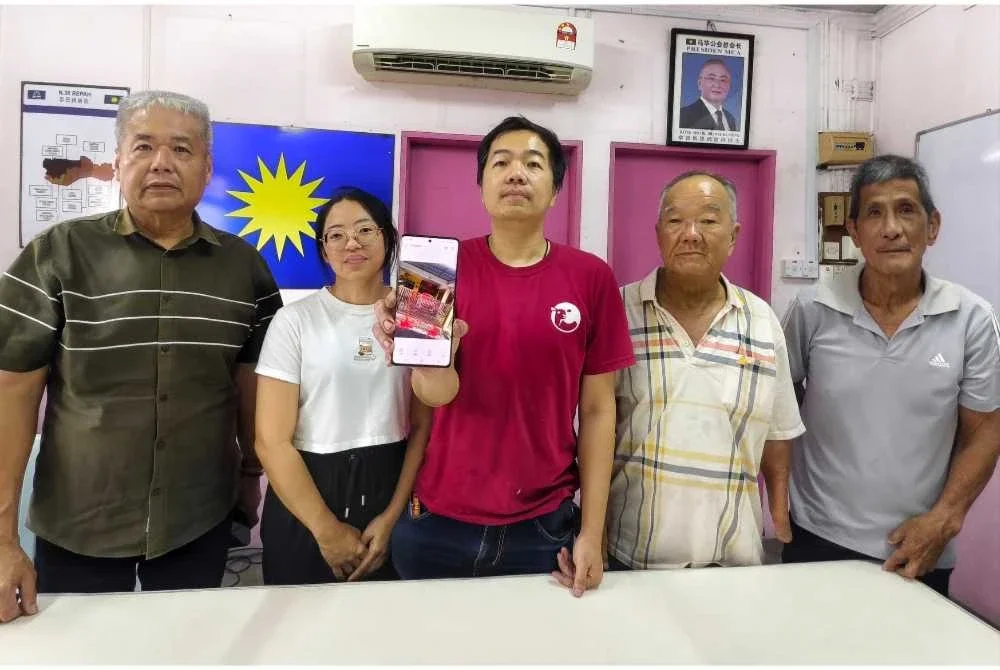 (Dari kiri) Kim Swee, Hui Ching, Ying Hau menunjukkan gambar keadaan rumah yang disimbah cat merah