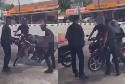 Tangkap layar dari video tular menunjukkan anggota menarik suspek dari motosikal sehingga terjatuh.