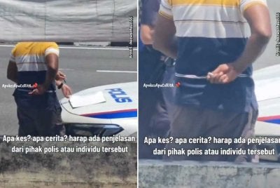 Tangkap layar video tular mendkwa seorang anggota polis menerima wang daripada seorang lelaki.