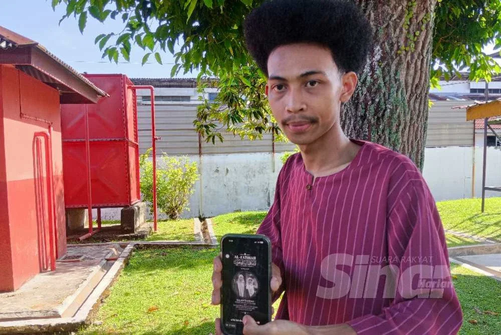 Anak ketiga mangsa, Mohd Aiman menunjukkan gambar ibu bersama adiknya.