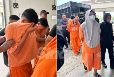 Kesemua suspek termasuk pasangan warga emas dikawal polis ketika berjalan masuk ke lokap mahkamah. 
