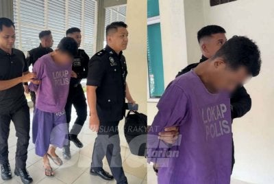Tertuduh dikawal ketat polis ketika berjalan menuju ke lokap mahkamah. FOTO - ADILA SHARINNI WAHID