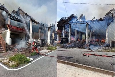 Anggota bomba sedang memadamkan bangunan di Tapak Pesta Pulau Pinang yang terbakar pada petang Isnin.