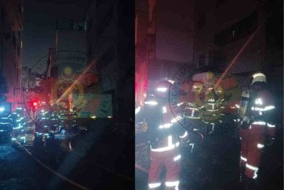 Anggota bomba memadamkan kebakaran di rumah kedai di Kuala Lumpur pada Selasa. 