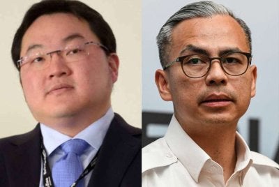 Fahmi Fadzil (kanan), Jho Low