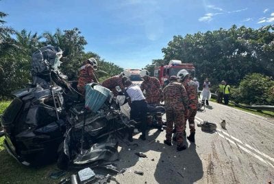 Anggota bomba mengeluarkan mangsa yang tersepit dalam MPV selepas terbabit kemalangan dengan treler muatan kelapa sawit di Jalan Kulai-Kota Tinggi berhampiran simpang Felda Taib Andak, Kulai.- Foto JBPM Johor