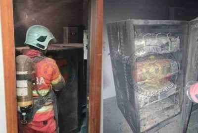Anggota bomba memadamkan kebakaran di bilik UPS Bank Negara pada Jumaat.