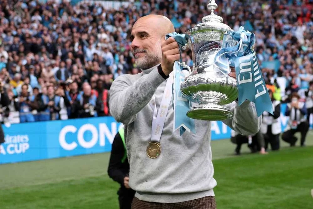 Guardiola membawa City meraih trofi kedua musim ini selepas pasukannya menundukkan Chelsea 1-0 pada final Piala FA di Wembley. - FOTO: Agensi