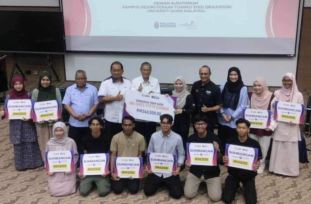 Norliza (lima dari kanan), Samsuri (lima dari kiri) dan Farizul Zainudin (tengah) bergambar bersama penerima sumbangan Program Sinar Kasih UDA Cares - PTPTN (SAKURA).