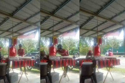 Tangkap layar video tular memaparkan aksi dua lelaki melarikan wang hasil jualan gerai nasi bajet di Meru Raya, Ipoh pada Khamis.