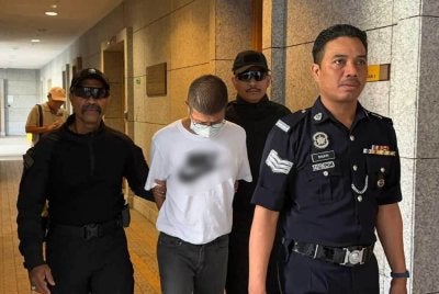 Kok Wah yang memakai baju-T berwarna putih dibawa ke Mahkamah Majistret Putrajaya pada Jumaat bagi menghadapi pertuduhan kes.