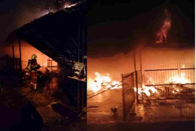 Anggota bomba menjalankan operasi pemadaman kebakaran yang melibatkan lima rumah teres di Taman Londang, Parit Raja, malam Jumaat. - Foto JBPM Johor