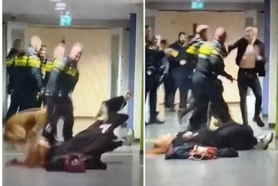 Seorang anggota polis yang dirakam dipercayai menolak seorang wanita ke lantai sebelum terlibat dalam pertengkaran dengan seorang lelaki yang berada berhampiran wanita tersebut. Foto Metro Uk.
